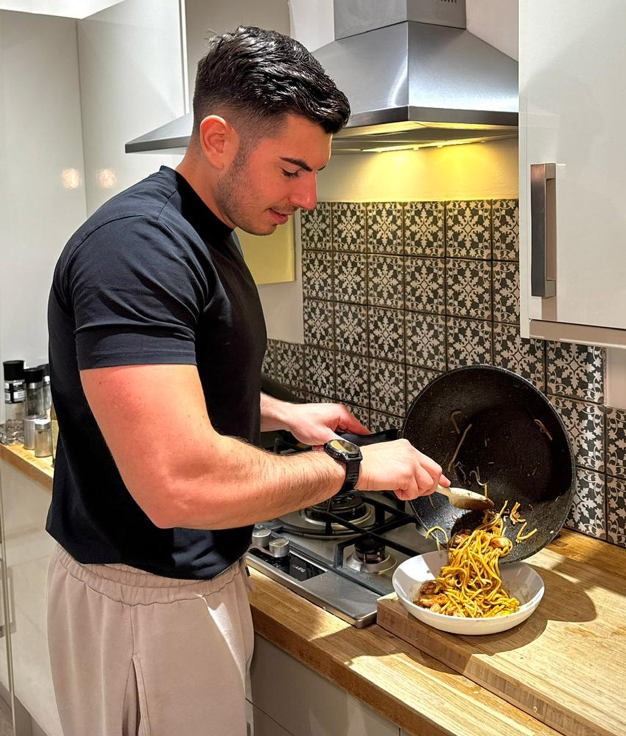 Coach cooking a meal in a kitchen.
